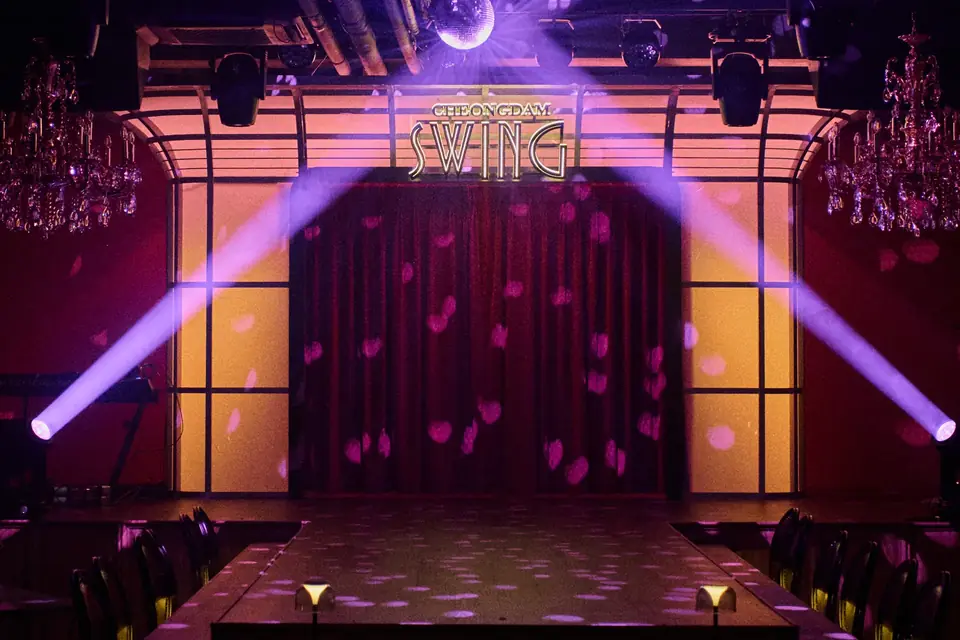 보랏빛 무빙 라이트가 교차하는 청담스윙 무대와 SWING 사인
